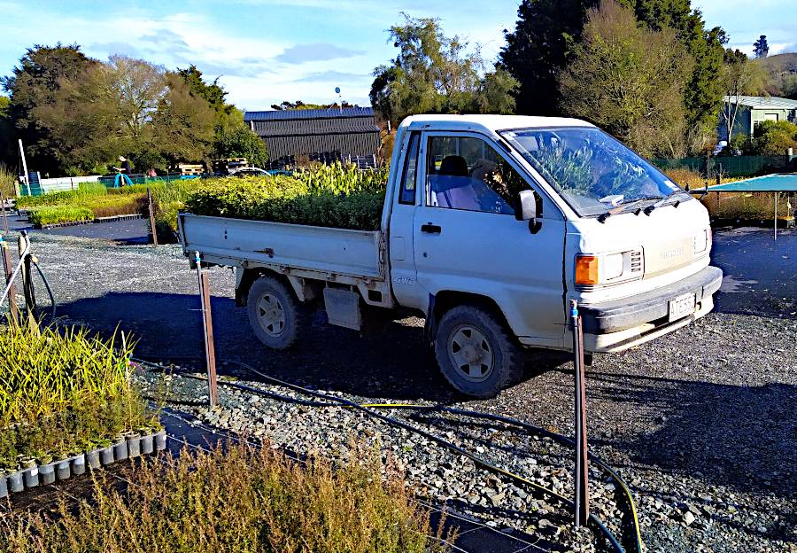 A side on picture of the little truck loaded up. Plants can just be seen on the passenger seat