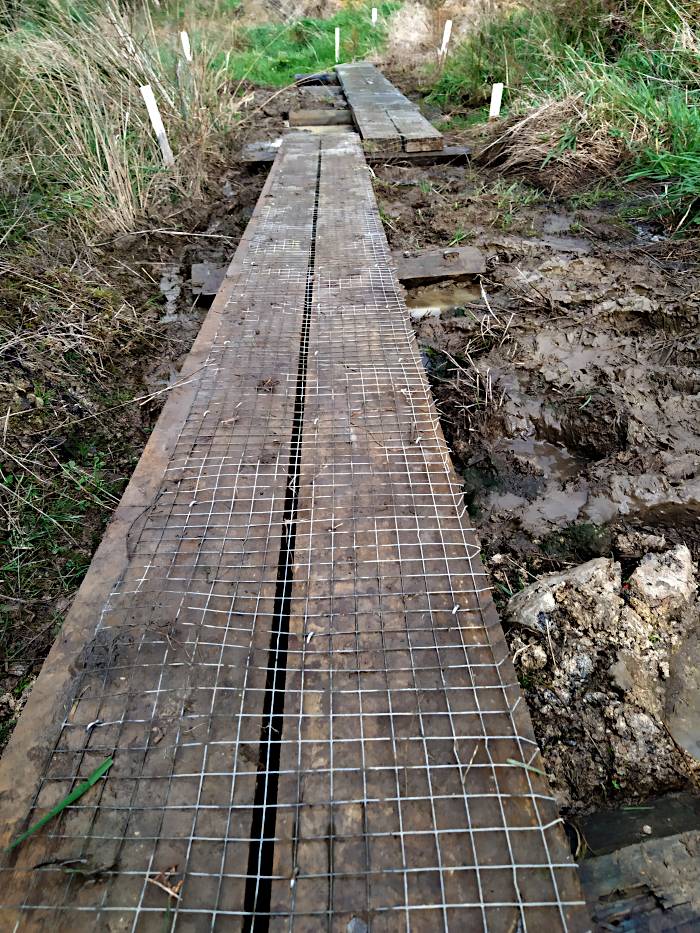 A picture of the wooden boardwalk through the wet area covered in anti-slip netting