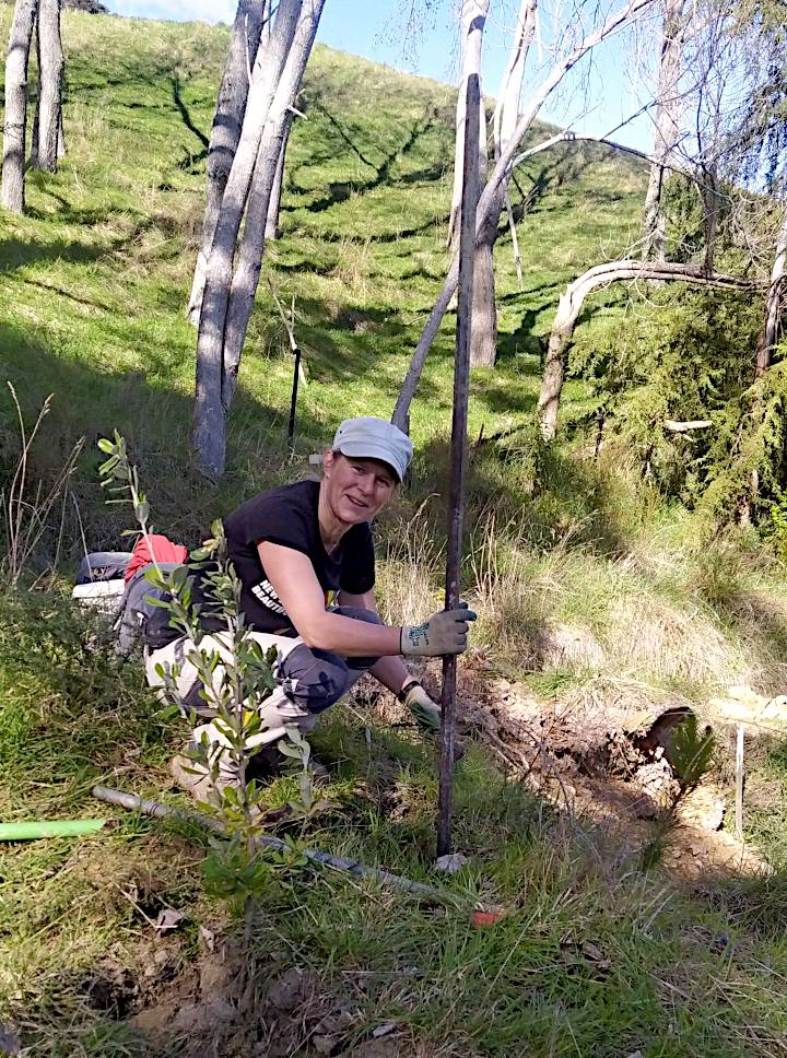 Jules loosening up earth with a crowbar